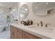 Double vanity in a modern bathroom featuring bronze faucets, wooden drawers, and a luxurious rainfall shower at 3010 E Glenrosa Ave, Phoenix, AZ 85016