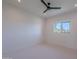 This bedroom has a ceiling fan and a window with a view of palm trees at 3010 E Glenrosa Ave, Phoenix, AZ 85016