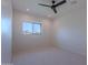 This bedroom has a ceiling fan and a window with a view of the neighborhood at 3010 E Glenrosa Ave, Phoenix, AZ 85016