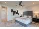 This primary bedroom features a tufted headboard, stylish ceiling fan, and modern artwork at 3010 E Glenrosa Ave, Phoenix, AZ 85016