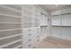 Spacious closet with wooden floors, white shelves, and black hardware at 3010 E Glenrosa Ave, Phoenix, AZ 85016