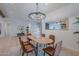 Bright dining room features a modern chandelier, wood table, and stylish chairs, perfect for entertaining guests at 3010 E Glenrosa Ave, Phoenix, AZ 85016
