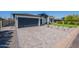 Spacious gray brick driveway leads to a modern home with a gray garage door and desert landscape at 3010 E Glenrosa Ave, Phoenix, AZ 85016