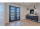 Elegant entryway with double glass doors, modern decor, and wood flooring in a herringbone pattern at 3010 E Glenrosa Ave, Phoenix, AZ 85016