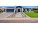 Inviting home exterior with well-maintained landscaping, a gray brick driveway, and a modern design at 3010 E Glenrosa Ave, Phoenix, AZ 85016