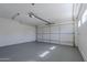 Clean, open garage with white walls and gray epoxy flooring at 3010 E Glenrosa Ave, Phoenix, AZ 85016