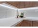 Kitchen countertop with wooden cabinets, white countertops and backsplash, and decorations at 3010 E Glenrosa Ave, Phoenix, AZ 85016