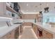 Modern kitchen featuring stainless steel appliances, wooden cabinets, and luxurious marble countertops at 3010 E Glenrosa Ave, Phoenix, AZ 85016