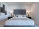 An upholstered headboard surrounded by white and black decor creates an elegant main bedroom at 3010 E Glenrosa Ave, Phoenix, AZ 85016