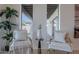 Cozy sitting area with comfortable chairs and throw pillows near bright windows and house plants at 3010 E Glenrosa Ave, Phoenix, AZ 85016