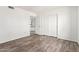 Bright bedroom showcasing updated wood-look flooring and closet at 7061 E Broadway Rd # 48, Mesa, AZ 85208