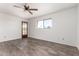 Bedroom boasts wood-look floors, natural light, ceiling fan, and exterior access at 7061 E Broadway Rd # 48, Mesa, AZ 85208