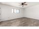 Bedroom with ceiling fan, wood-look floors, and natural light from the window at 7061 E Broadway Rd # 48, Mesa, AZ 85208