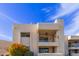 Cream colored three-story building with private balconies at 7061 E Broadway Rd # 48, Mesa, AZ 85208