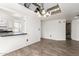 Open-concept living room with breakfast bar, mirrored ceiling feature and sleek flooring at 7061 E Broadway Rd # 48, Mesa, AZ 85208