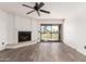 Bright living room featuring a fireplace, ceiling fan, and sliding doors to the balcony at 7061 E Broadway Rd # 48, Mesa, AZ 85208