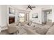 Bright living room featuring a cozy fireplace, modern furnishings, and sliding glass doors to the outside at 7061 E Broadway Rd # 48, Mesa, AZ 85208
