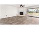 Spacious living room featuring a fireplace, ceiling fan, and sliding glass doors to the outdoors at 7061 E Broadway Rd # 48, Mesa, AZ 85208