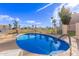 Community pool area featuring lounge chairs and palm trees at 7061 E Broadway Rd # 48, Mesa, AZ 85208
