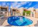 Community pool surrounded by well-maintained condos and blue skies at 7061 E Broadway Rd # 48, Mesa, AZ 85208