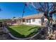 Fenced backyard featuring artificial turf and landscaping for low maintenance enjoyment at 8757 W El Caminito Dr, Peoria, AZ 85345
