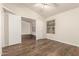 Bedroom with hardwood floor, ceiling fan, and plenty of natural light at 8757 W El Caminito Dr, Peoria, AZ 85345