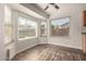 Cozy breakfast nook bathed in natural light from large windows, complemented by modern wood flooring at 8757 W El Caminito Dr, Peoria, AZ 85345