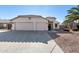 Well-maintained single-Gathering home with a spacious three-car garage and desert landscaping at 8757 W El Caminito Dr, Peoria, AZ 85345