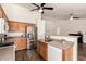 Bright kitchen featuring stainless steel appliances and wood cabinets with an adjacent living area at 8757 W El Caminito Dr, Peoria, AZ 85345