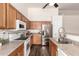 Well-lit kitchen featuring wooden cabinetry, stainless steel appliances, and a practical layout at 8757 W El Caminito Dr, Peoria, AZ 85345
