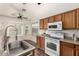 Bright kitchen featuring modern appliances, wood cabinets, and a bay window over the kitchen sink at 8757 W El Caminito Dr, Peoria, AZ 85345