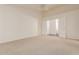Bright living room with neutral carpet, ready to make it your own at 8757 W El Caminito Dr, Peoria, AZ 85345