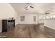 Bright, open living space with sleek wood floors, an electric fireplace, and abundant natural light at 8757 W El Caminito Dr, Peoria, AZ 85345