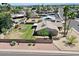 An aerial view of the home's spacious backyard, which features a lawn, patio, and privacy fence at 9719 N 45Th Ave, Glendale, AZ 85302