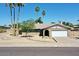 Charming single-story home with a well-maintained front yard and desert landscaping under a clear blue sky at 9719 N 45Th Ave, Glendale, AZ 85302
