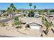 An elevated angle captures the home's desert landscape, palm trees, and arched entryway at 9719 N 45Th Ave, Glendale, AZ 85302