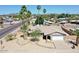 An aerial shot captures the facade, landscaping, and desert-style front yard of this charming single-Gathering home at 9719 N 45Th Ave, Glendale, AZ 85302