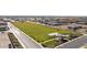 Community park featuring a large open grassy area surrounded by trees and well-maintained sidewalks at 11422 E Utah Ave, Mesa, AZ 85212