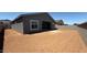 Expansive backyard showcasing the home's exterior, windows, and patio, creating an ideal entertainment space at 11422 E Utah Ave, Mesa, AZ 85212