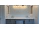 Bathroom with double sinks, gray cabinetry, and modern lighting at 11422 E Utah Ave, Mesa, AZ 85212