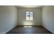 A clean, empty bedroom with tile flooring, a window, and neutral walls offers versatile design options at 11422 E Utah Ave, Mesa, AZ 85212