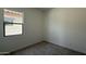 Cozy carpeted bedroom with neutral walls and window at 11422 E Utah Ave, Mesa, AZ 85212