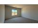 Bedroom features a large window and neutral carpet at 11422 E Utah Ave, Mesa, AZ 85212