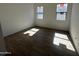 Well-lit bedroom showcasing beautiful tile flooring and two large windows for natural light at 11422 E Utah Ave, Mesa, AZ 85212