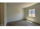 Well-lit bedroom features tile flooring, neutral walls, and a window, ready for personalization and decor at 11422 E Utah Ave, Mesa, AZ 85212