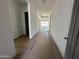 Bright hallway featuring sleek tile flooring and crisp white walls leading to the main living area at 11422 E Utah Ave, Mesa, AZ 85212
