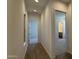 Hallway featuring wood floors connecting bedrooms and bathrooms in the house at 11422 E Utah Ave, Mesa, AZ 85212