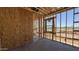 This image captures the interior framing of a home, with exposed studs, window openings, and a concrete floor at 11422 E Utah Ave, Mesa, AZ 85212