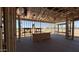 View of a room under construction, featuring exposed framework, multiple windows, and a smooth concrete floor at 11422 E Utah Ave, Mesa, AZ 85212