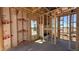 The image showcases the interior framing of a house, highlighting the structural elements and window placements at 11422 E Utah Ave, Mesa, AZ 85212